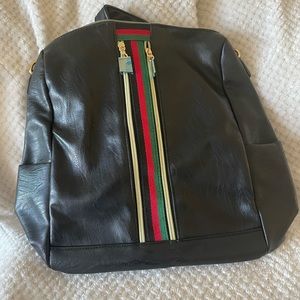 NEW! Black backpack with green and red strap. still has wrapping on straps